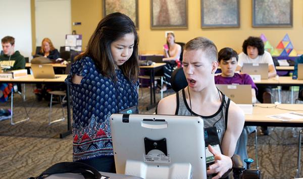 Two students with disabilities work together on the computer.