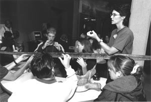 Image of an instructor working with students with disabilities in a hands on activity.