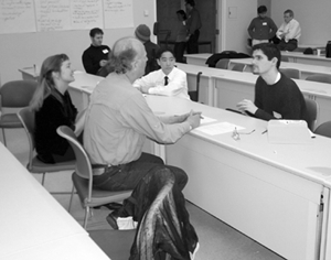 Image of students participating in mock interviews with employees.