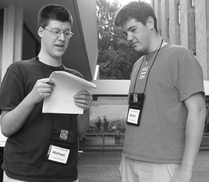 Photo of two students looking over a set of forms.
