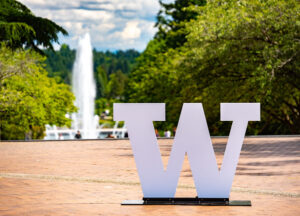 W logo sign with Drumheller fountain in background